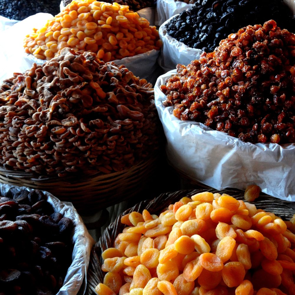 Dried organic apricots, plums and walnuts on a market stall in Malatya, Turkey.